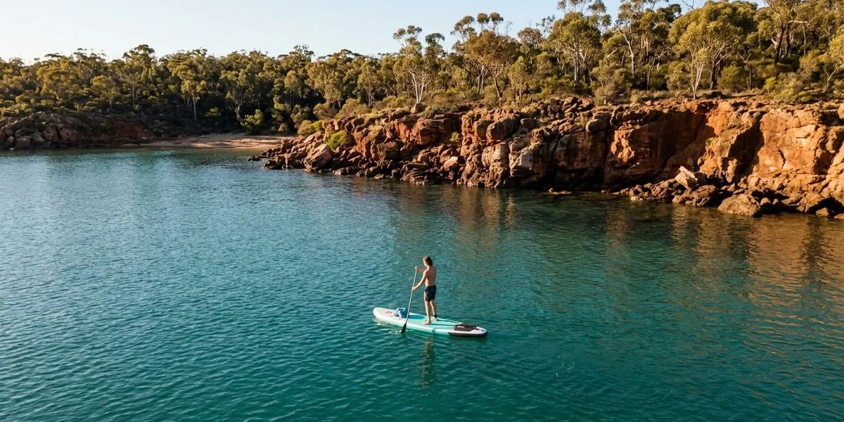 Inflatable paddle board on turquoise water at a calm WA bay
